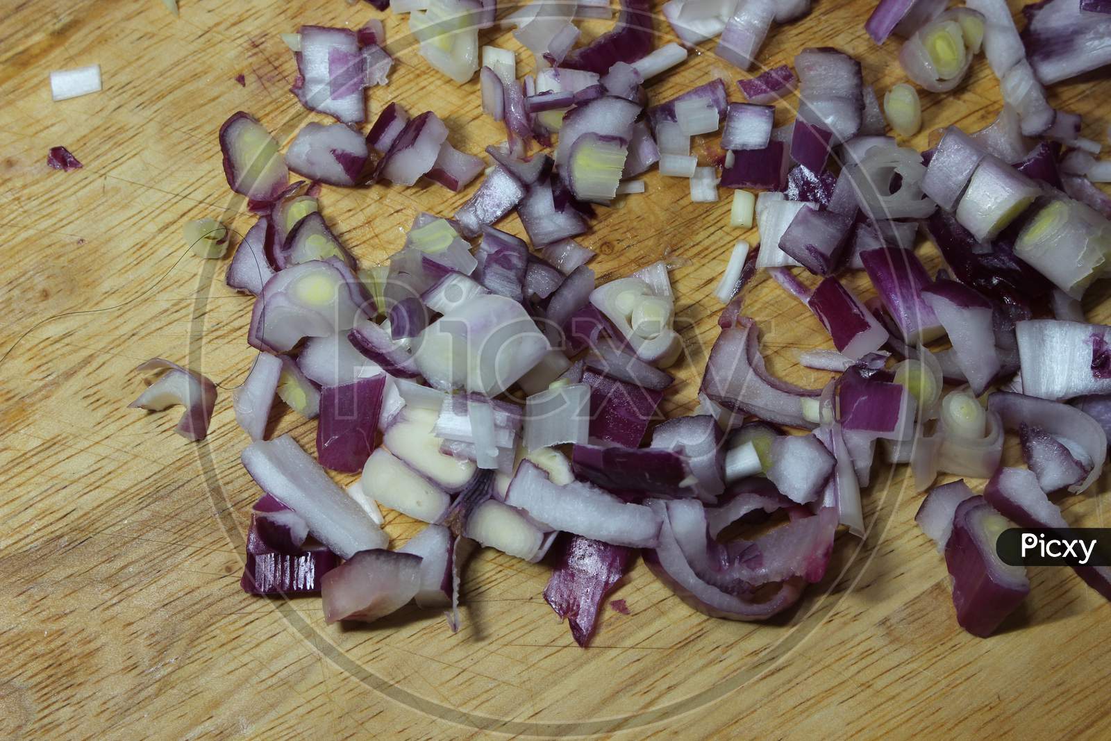 Chopped White Onion With Sharp Knife On Wooden Cutting Board