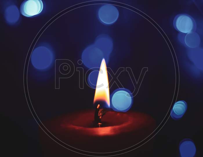 Candle lights in darkness with light effects and bokeh for solemn moments and wallpaper. Candle flame light at night with background.