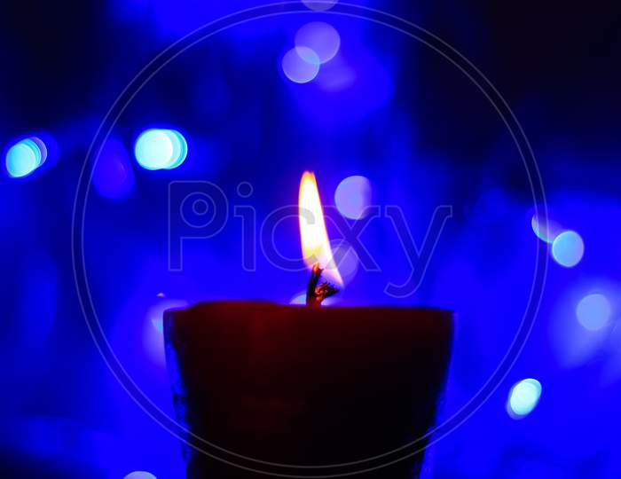 Candle lights in darkness with light effects and bokeh for solemn moments and wallpaper. Candle flame light at night with background.