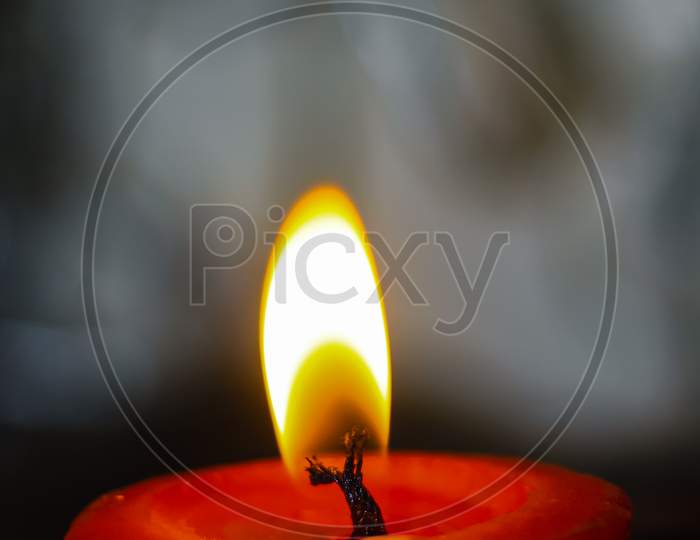 lighting candles, Burning candle on black background, Candle in the dark, Design for the background and wallpaper. copy space.