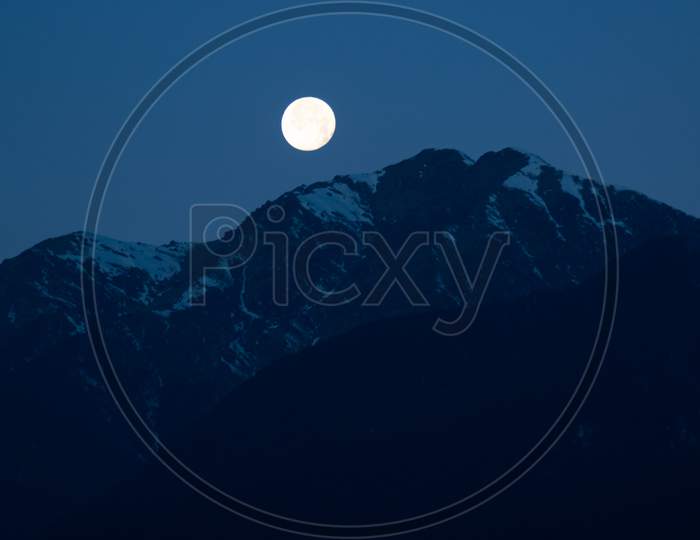 Bright Shining Moon Just Before The Sunrise Behind The Mountain