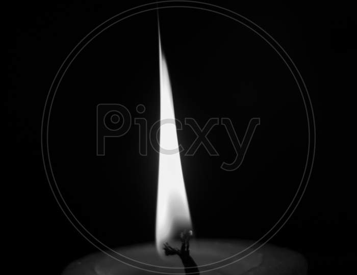 lighting candles, Burning candle on black background, Candle in the dark, Design for the background and wallpaper. copy space.