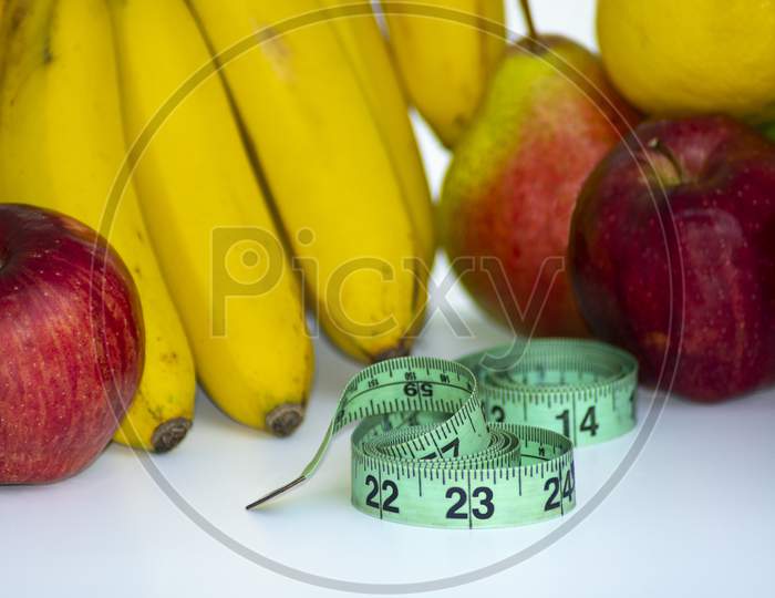 Set Of Fresh Fruits, Healthy Food With Measuring Tape On White Background. Diet Concept