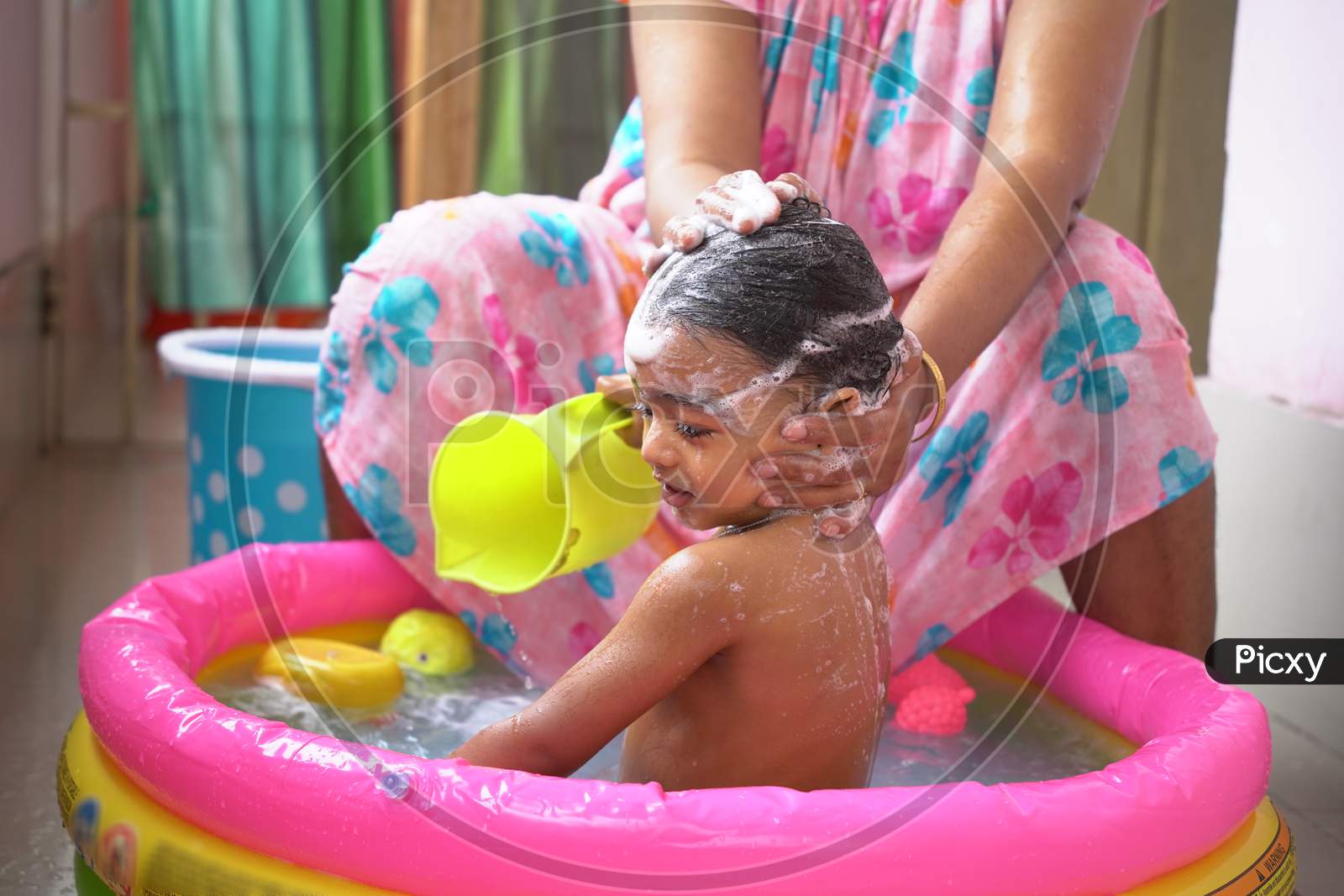 Indian Baby Boy Enjoying Bath In An Inflatable Pool