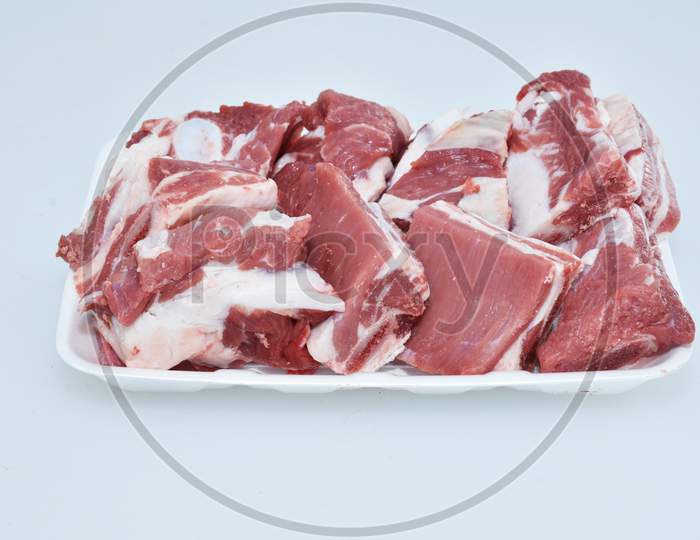 fresh chopped slices of lamb meat decorated in plate on white background,loin portion