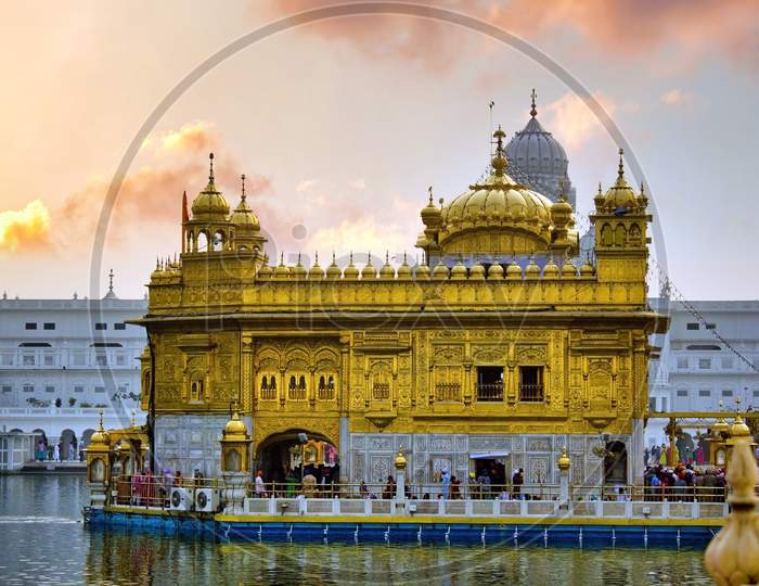 Amritsar, India - November 06, 2016: The Harmindar Sahib, Also Known As Golden Temple Amritsar. Sikhism Religious Place Of Worship. Sikh Gurdwara Golden Temple During Dramatic Sunrise