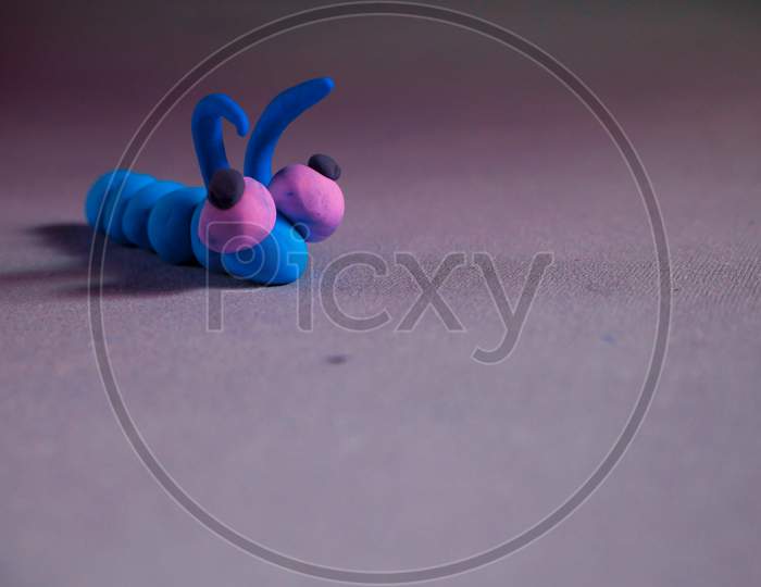 Blue Clay Warms Creature Cartoon Isolate On Light Background
