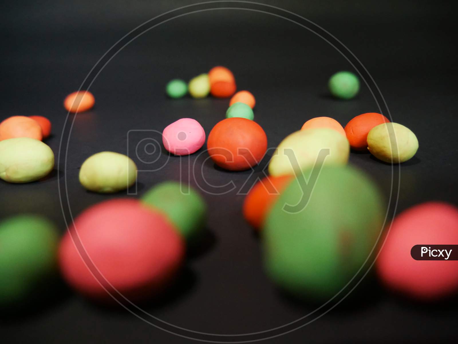 Colorful Clay Balls Presented On Dark Surface Commercial View