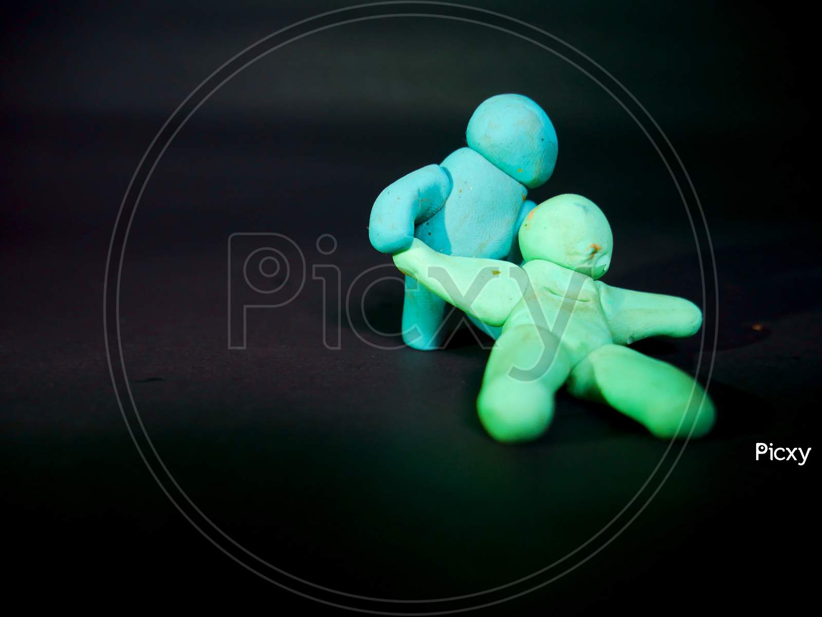 Two Clay Soft Toys Fighting On Black Background