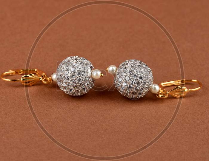 Beautiful Golden Pair Of Earrings,Diamond Earrings On Brrwon Background. Luxury Female Jewelry, Indian Traditional Jewellery, Kundan Earring,Bridal Gold Earrings Wedding Jewellery