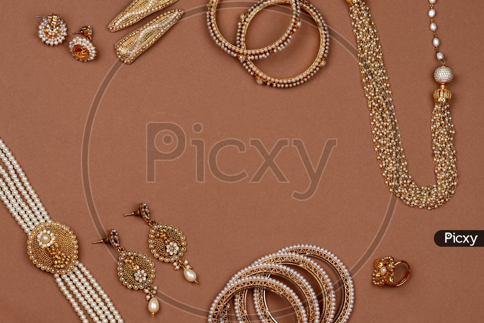Pearl Jewelry On A Brown Background,Golden Scarf, Pearl Bracelet,Pearl Hair Clip,Pearl Necklace Pearl Earrings,Finger Ring.Fashion And Design Of Jewelry. Indian Traditional Jewellery,Jewelry Backgrond
