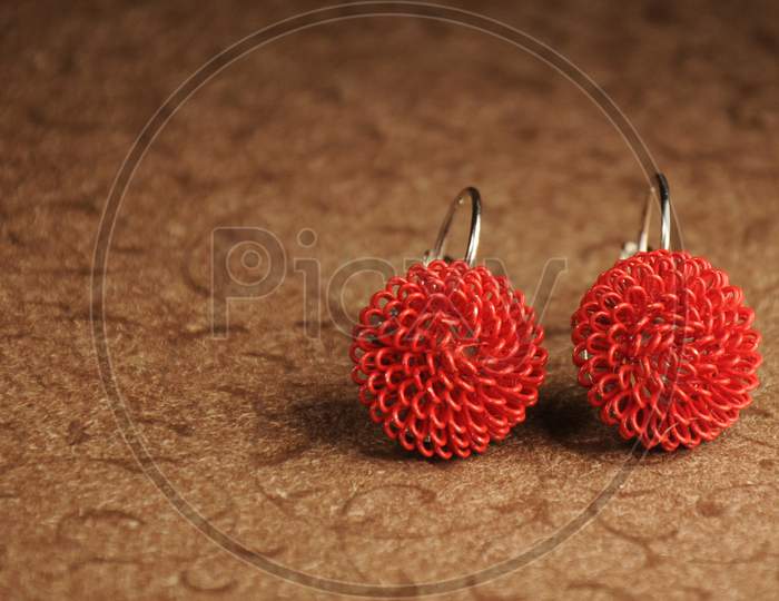 Close-Up Of A Pair Of Red Earrings