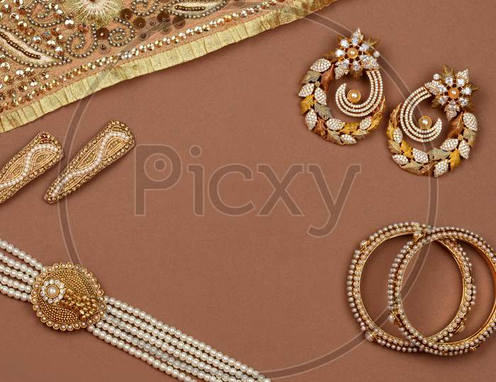 Pearl Jewelry On A Brown Background, Golden Scarf, Pearl Bracelet, Pearl Hair Clip, Pearl Necklace, Pearl Earrings,Jewelry Background.Style, Fashion And Design Of Jewelry. Indian Traditional Jewellery