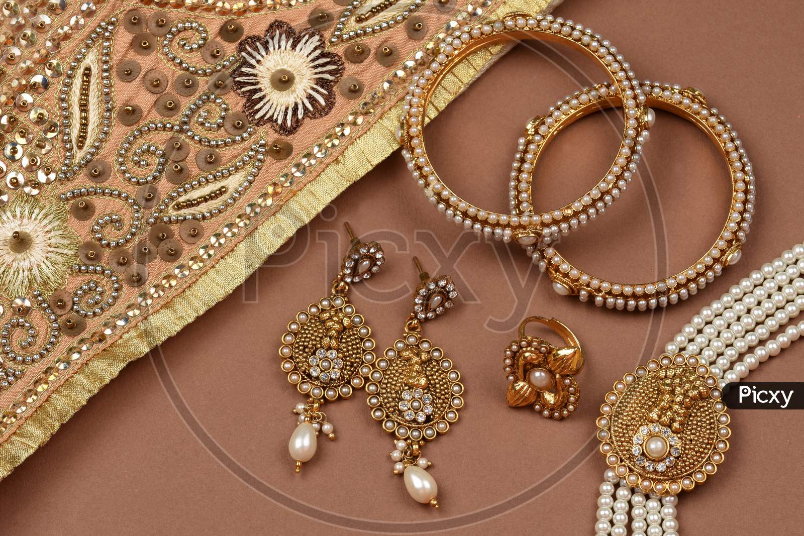 Pearl Jewelry On A Brown Background, Golden Scarf, Pearl Bracelet Jewelry Background, Pearl Necklace, Pearl Earrings, Finger Ring.Style, Fashion And Design Of Jewelry. Indian Traditional Jewellery