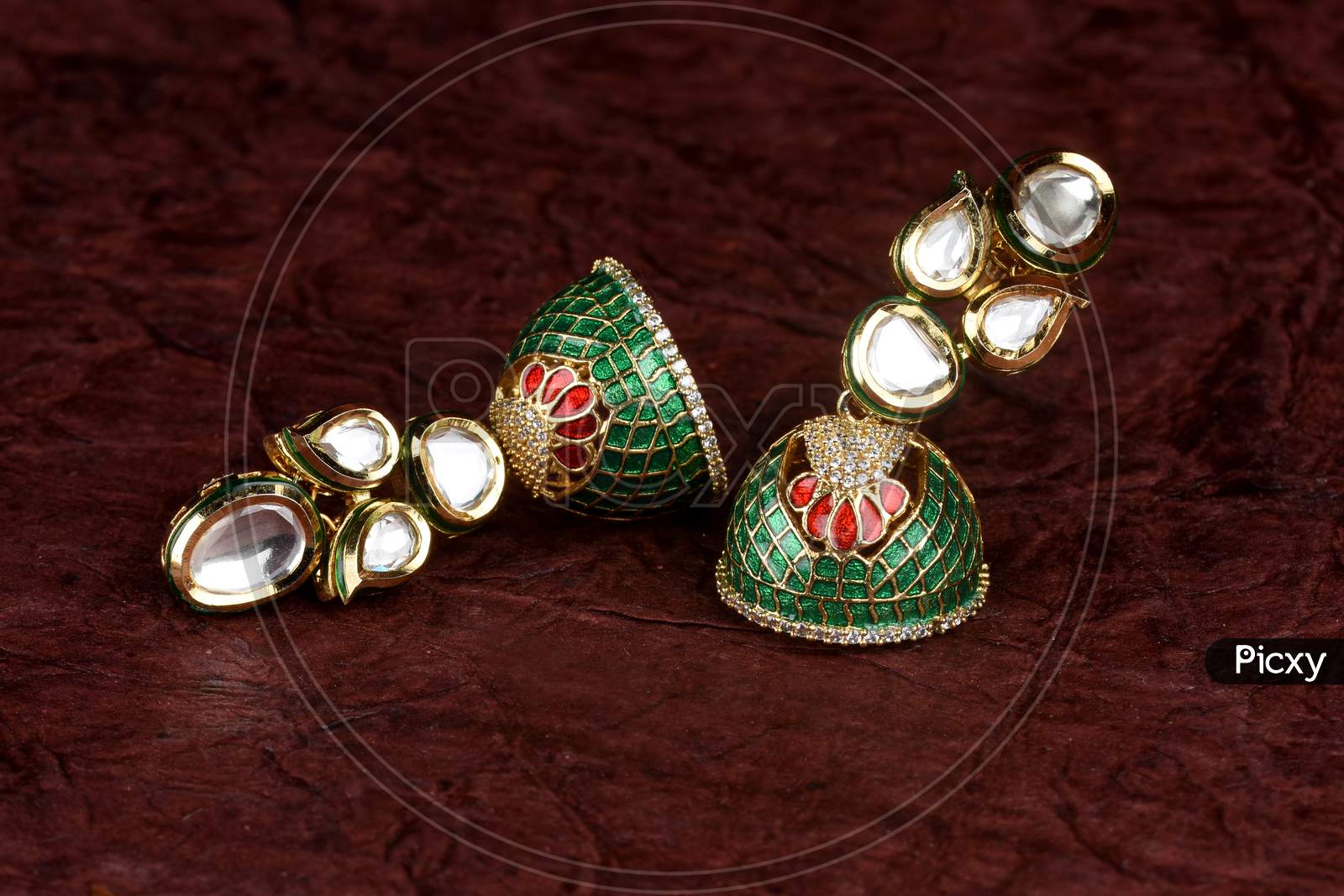Beautiful Golden Pair Of Earrings Diamonds Gemstones On Textued Background. Luxury Female Jewelry, Indian Traditional Jewellery, Kundan Earring,Bridal Gold Earrings Wedding Jewellery