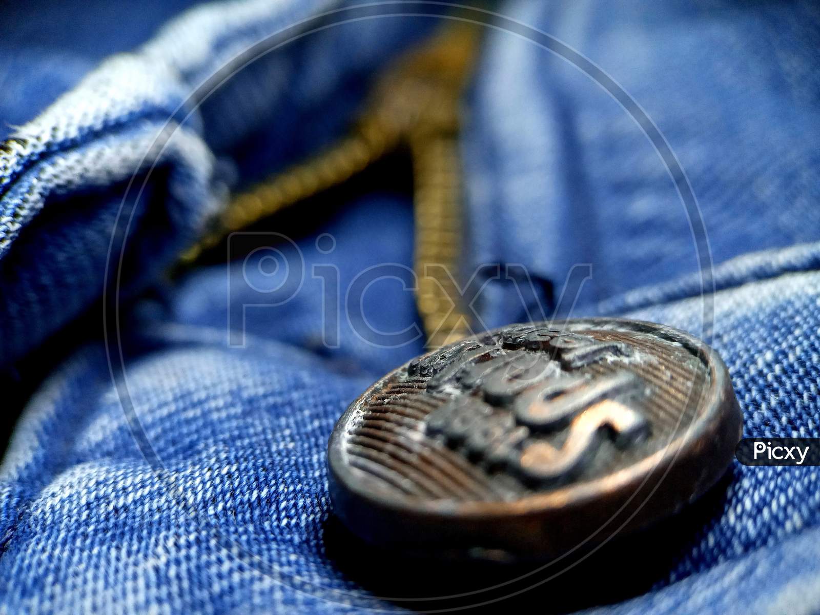macro photography of jeans bottom and zip