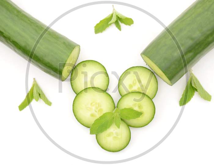Closeup Sliced Green Ripe Cucumber With Mint Isolated On White Background.
