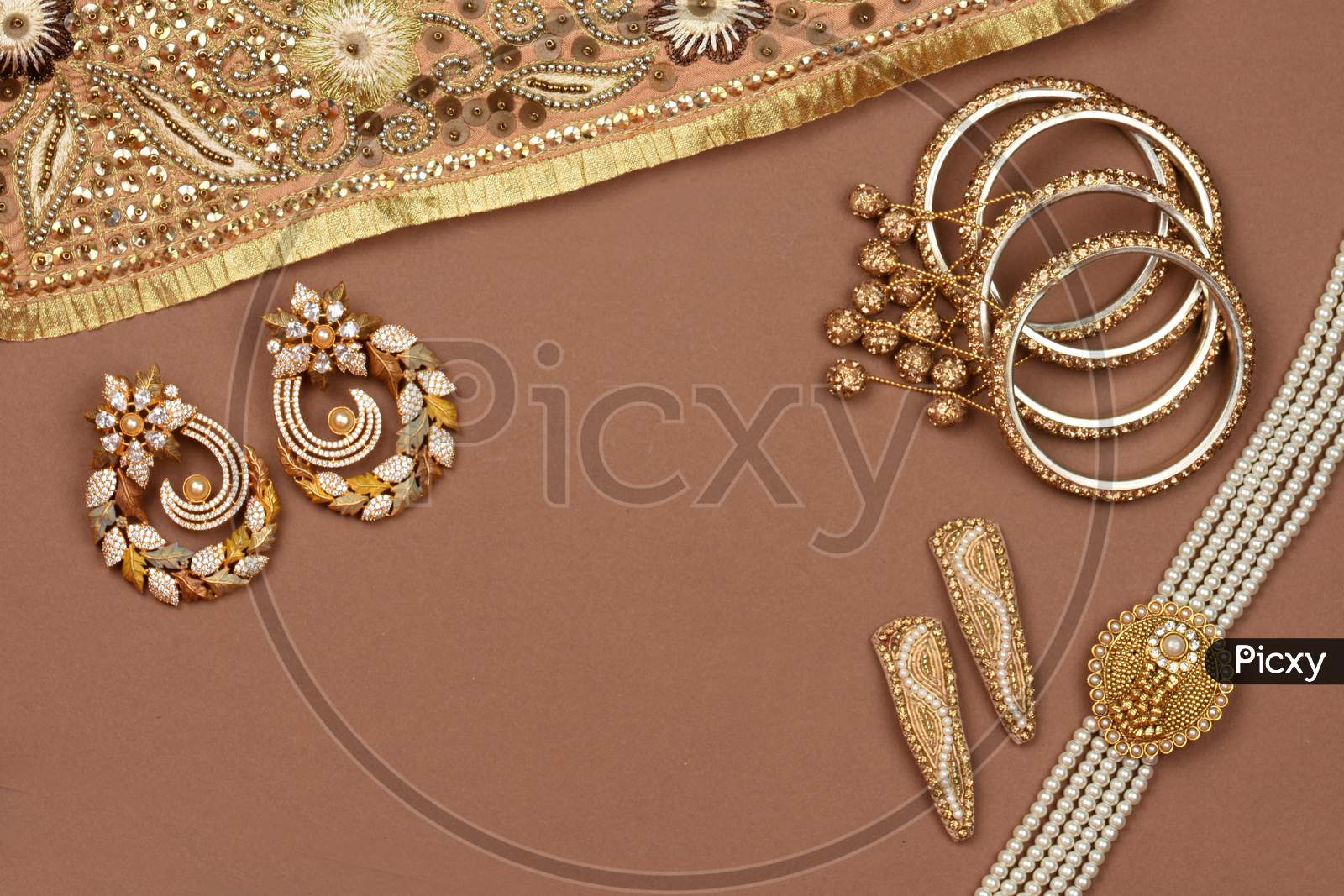 Pearl Jewelry On A Brown Background, Golden Scarf, Pearl Bracelet, Pearl Hair Clip, Pearl Necklace, Pearl Earringsjewelry Background.Style, Fashion And Design Of Jewelry. Indian Traditional Jewellery