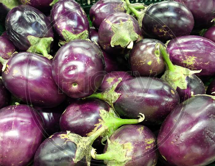 Top-down view of a heap of Brinjal on market .