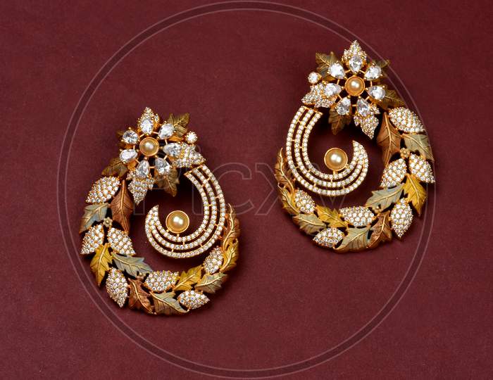 Glamorous Antique Golden Pair Of Earrings On Red Background. Luxury Female Jewelry, Indian Traditional Jewellery, Kundan Earring,Bridal Gold Earrings Wedding Jewellery,Vintage Earring