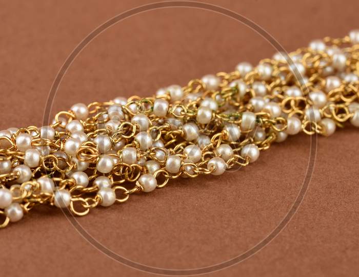 Pearl Jewelry On A Brown Background,  Pearl Bracelet,  Pearl Necklace, Pearl Earrings.Style, Fashion And Design Of Jewelry. Indian Traditional Jewellery
