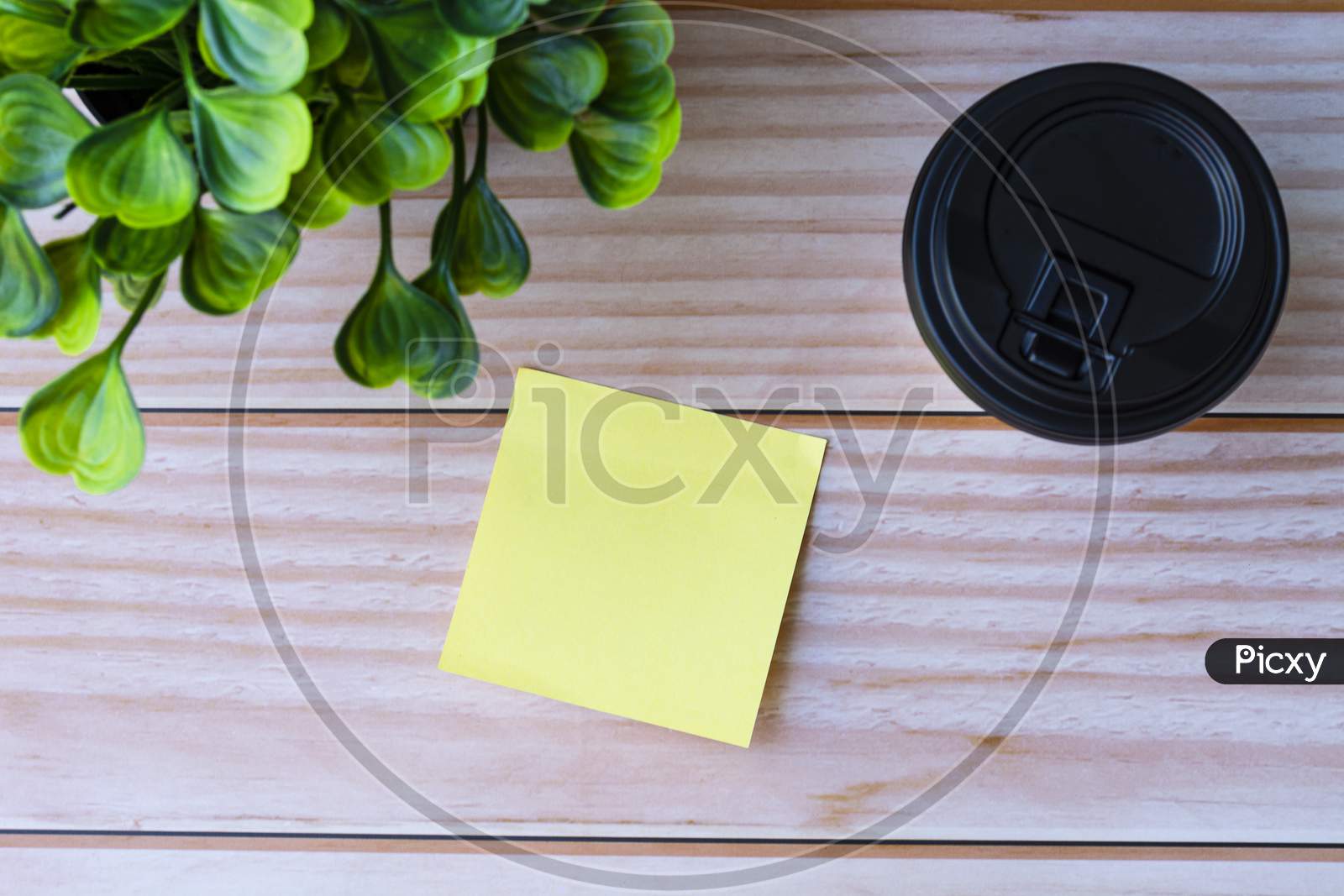 Yellow Stick Note With Coffee On Wooden Table. Space For Text