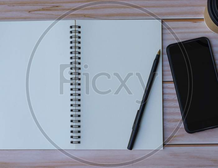 Note Book On Wooden Table. Space For Text. Flat Lay And Top View
