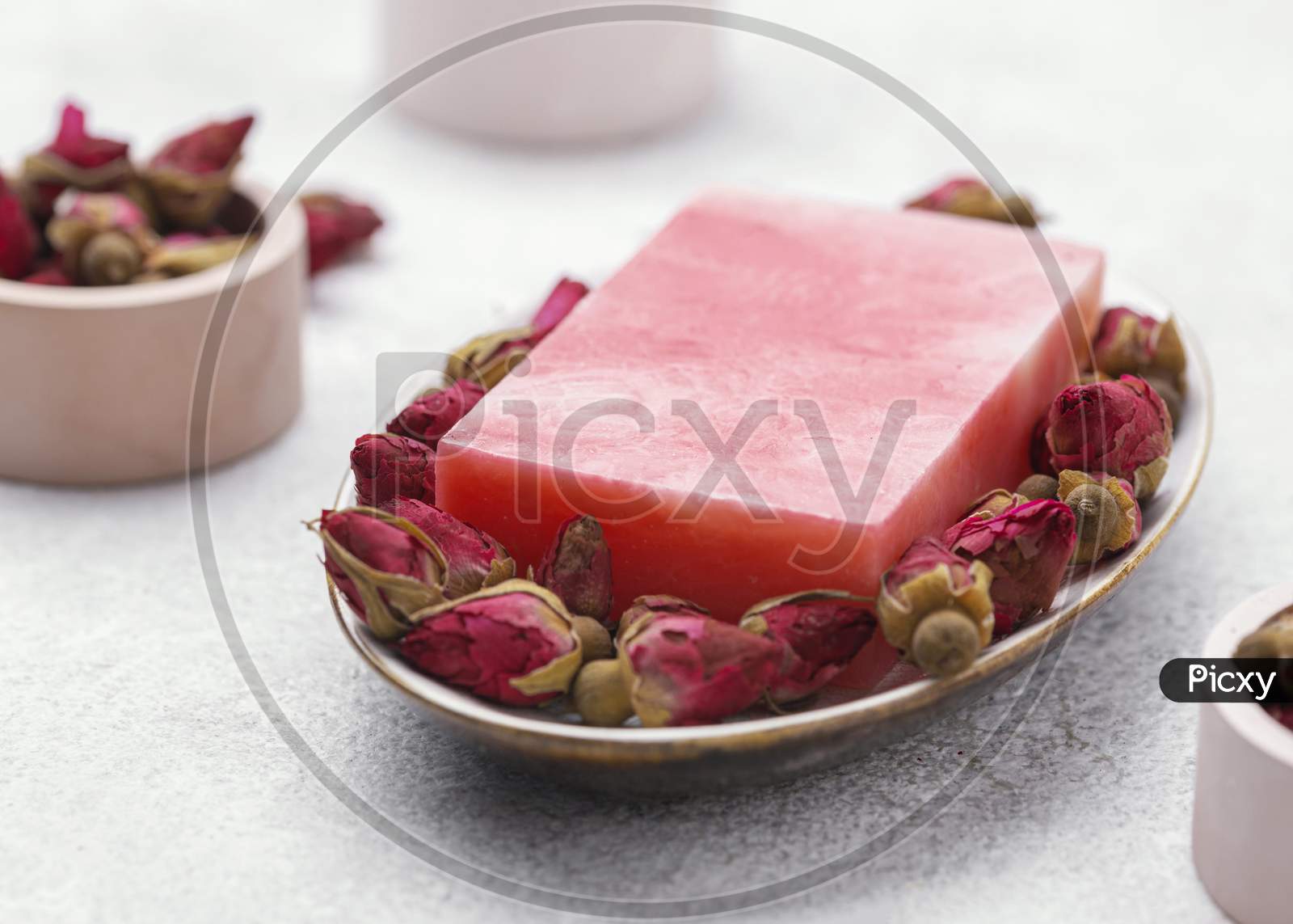 High angle pink homemade soap, spa still life with rose petals