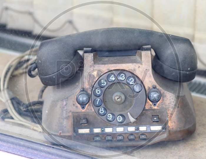 Old vintage telephone or retro wired telephone shows traditional telecommunication with analog connection of hot lines in antique offices and nostalgia with old-fashioned 70s look as unique designs