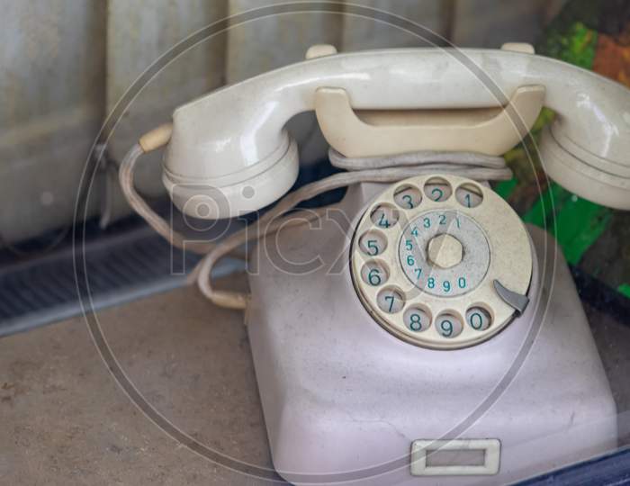 Old vintage telephone or retro wired telephone shows traditional telecommunication with analog connection of hot lines in antique offices and nostalgia with old-fashioned 70s look as unique designs