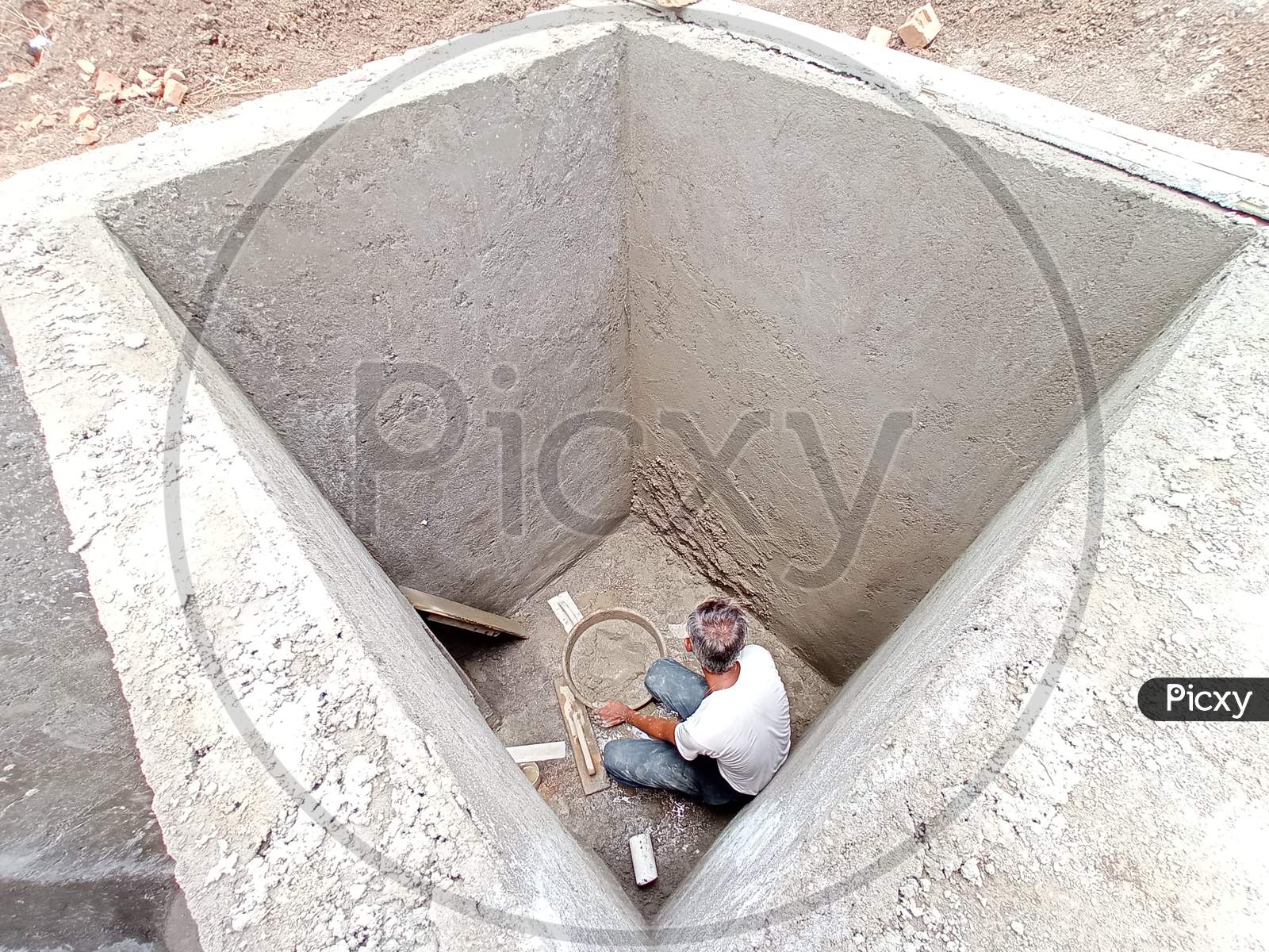 Skilled labour making septic tank.