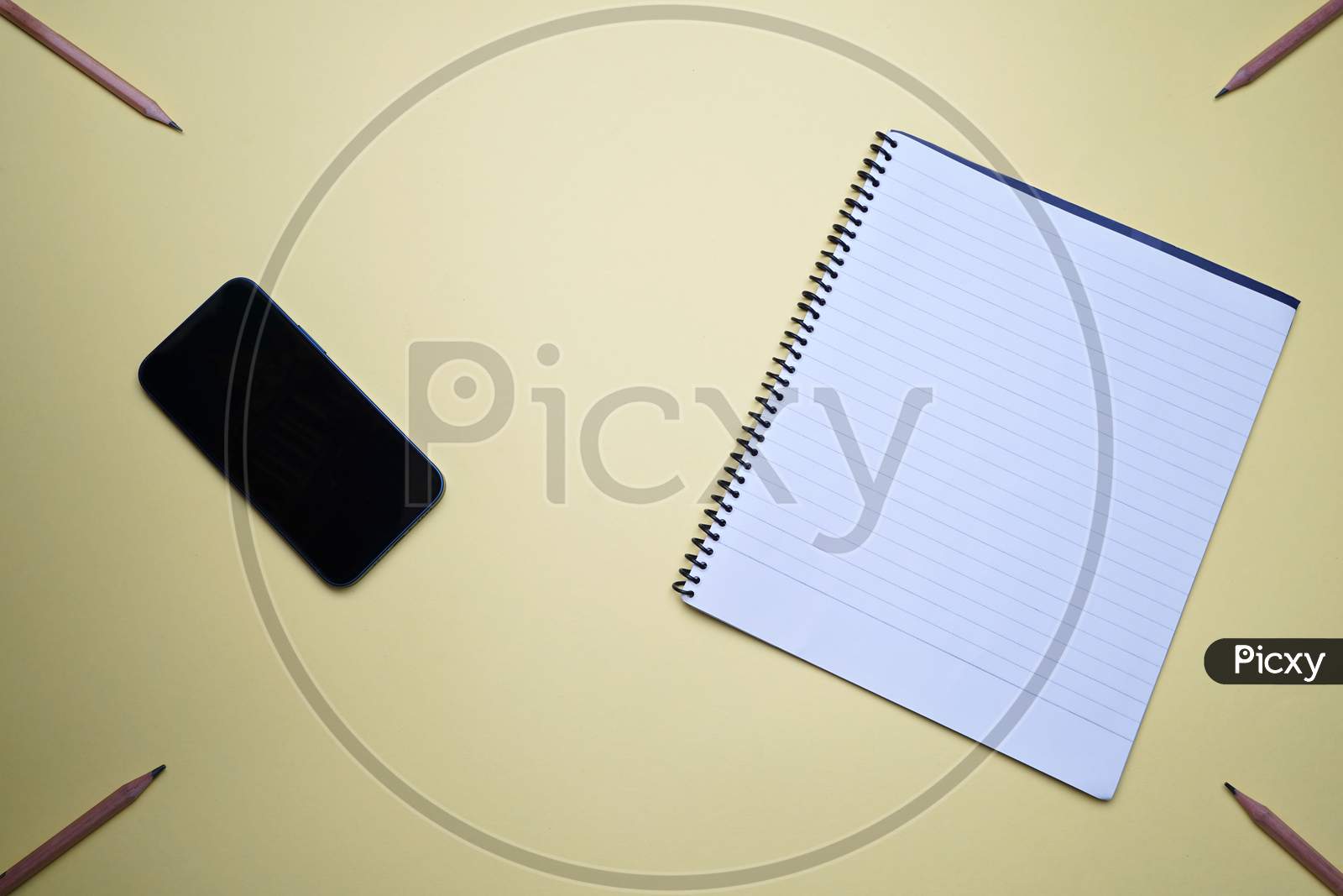 Business, Office, Student, Education Flat Lay, Table Top. Mobile, Phone, Spiral Notebook On Yellow Background