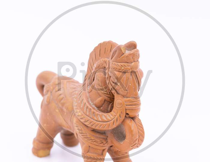 A horse made of clay with designs and patterns on it