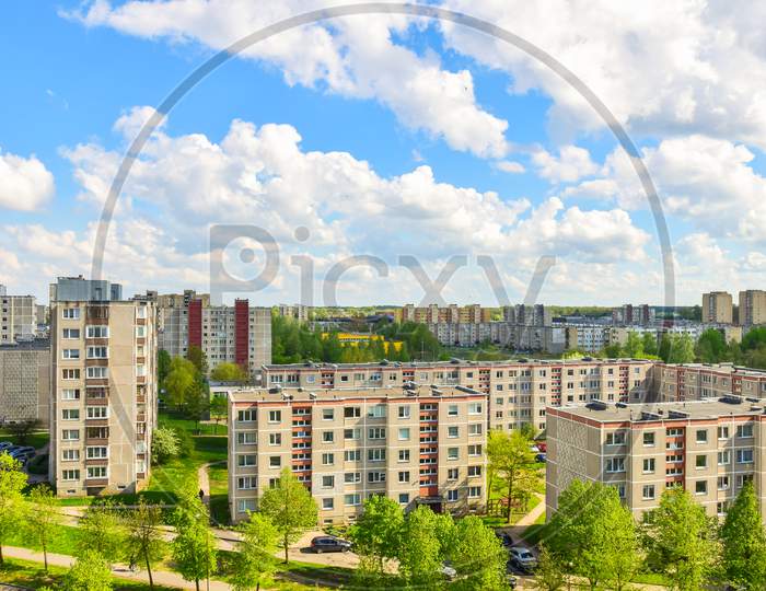 Aerial Panoramic View Of The Southern Part Of Siauliai City In Lithuania.Old Soviet Union Buildings With Green Nature Around And Yards Full Of Cars In A Sunny Day.