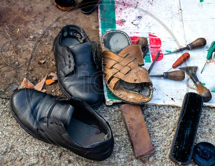 Stock Photo Of Local Indian Cobbler Shop Or Shoe Repair Shop. There Are Number Of Shoe Repair Tool Like Leather, Thread, Cutter, Brush, Stand Etc.