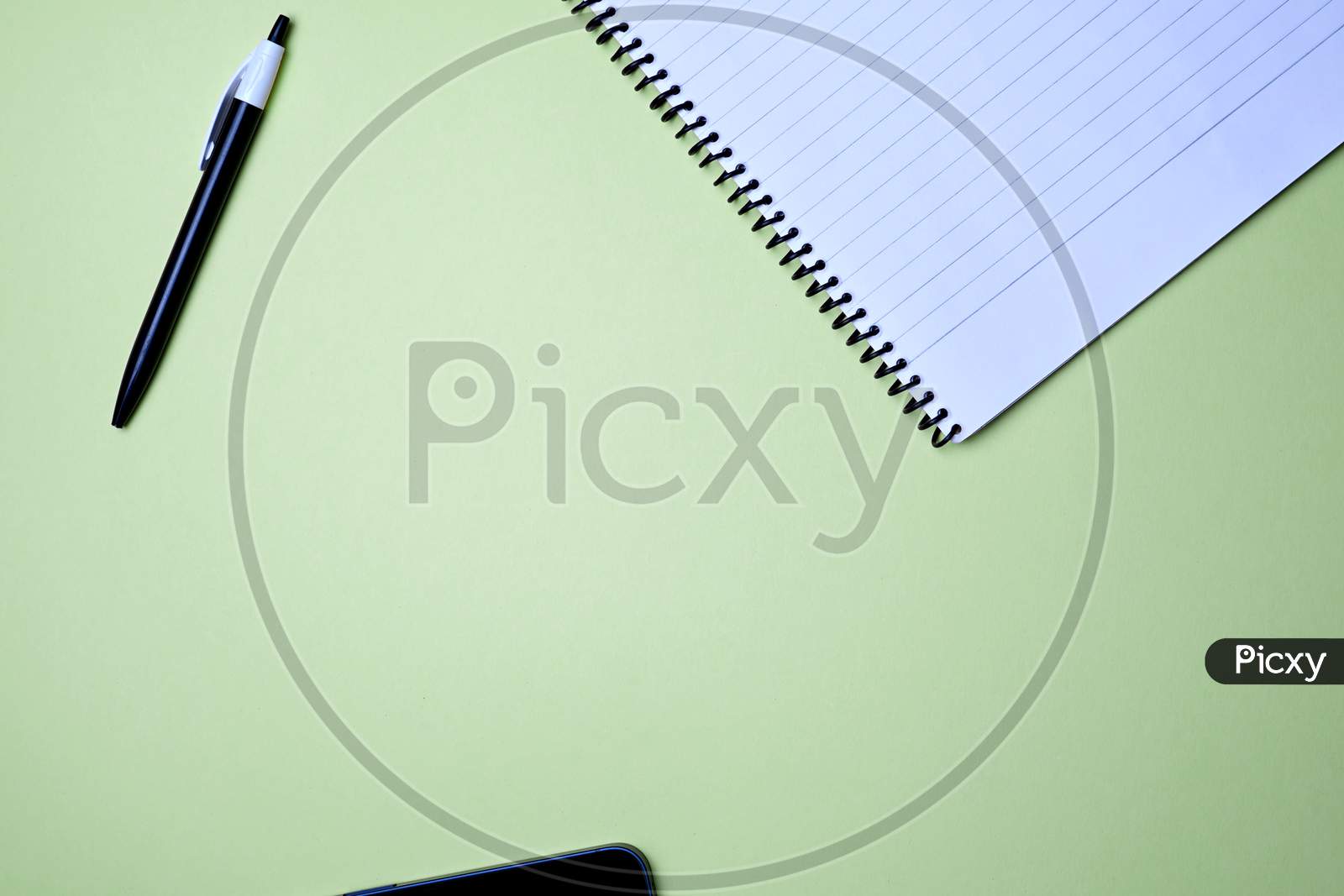 Business, Office, Student, Education Flat Lay, Table Top. Laptop, Spiral Notebook And Pen On Green Background