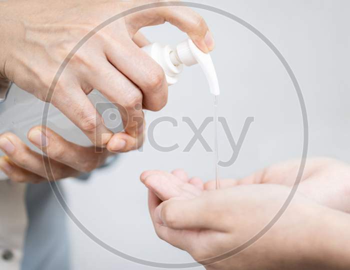 Closeup,hands of female using alcohol antiseptic gel,prevent infection of COVID-19 pandemic,people washing hand with hand sanitizer to clean or hygiene during Coronavirus outbreak,disinfection concept