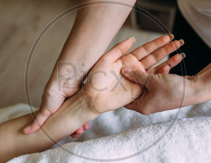 The Masseur Gives Massage To Female Hand At The Spa
