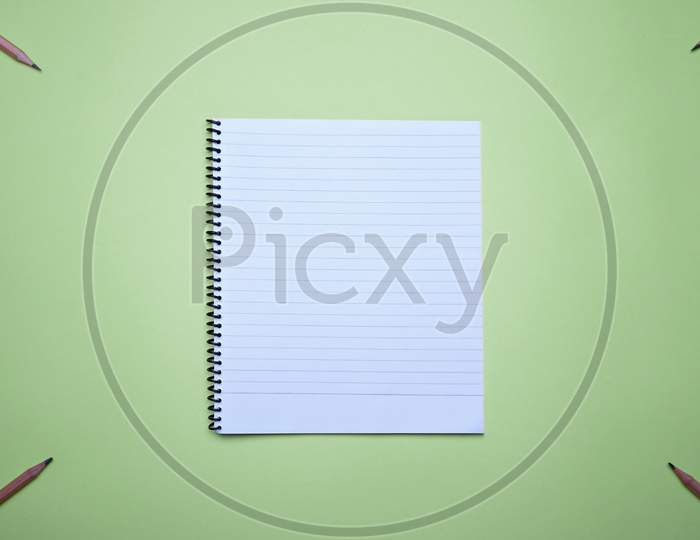 Spiral Notebook For Notes And Planning On A Green Background