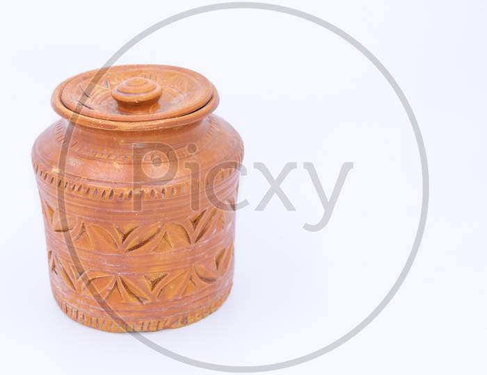 Close up of a jar made of clay with designs and patterns on it