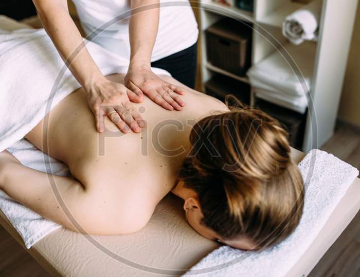 Massage Therapist Doing Massage On The Female Body In The Spa
