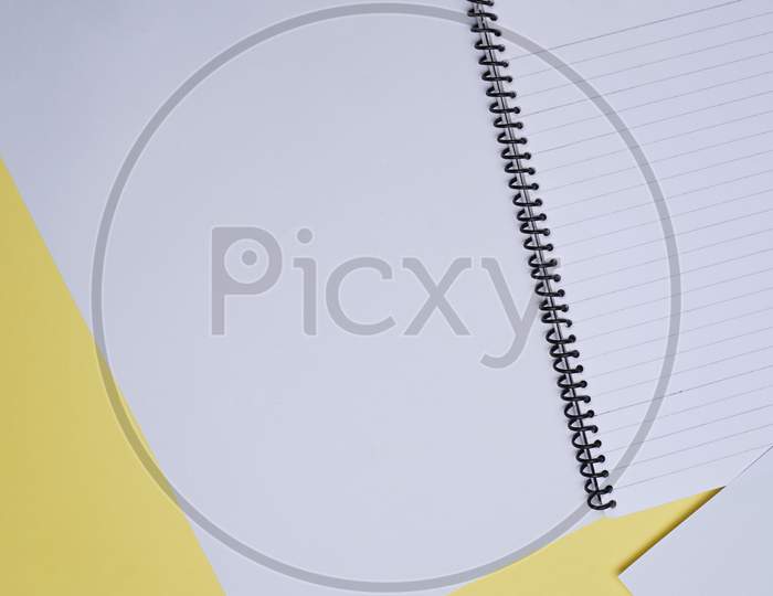 Business, Office, Student, Education Flat Lay, Table Top. White Sheets, Spiral. White Sheet, Spiral Notebook, On Yellow Background