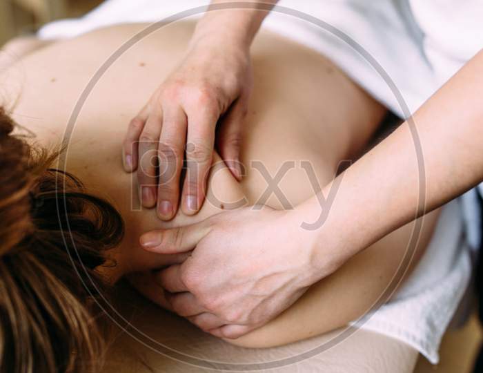 Massage Therapist Doing Massage On The Female Body In The Spa.