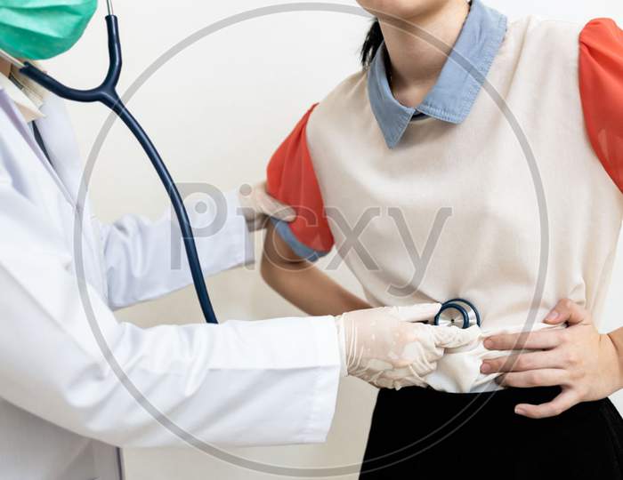 child girl with flatulence,bloated stomach checking the abdomen,physical examination,doctor using a stethoscope,listen to the sound of bowel movement,indigestion,pain illness,abdominal problems