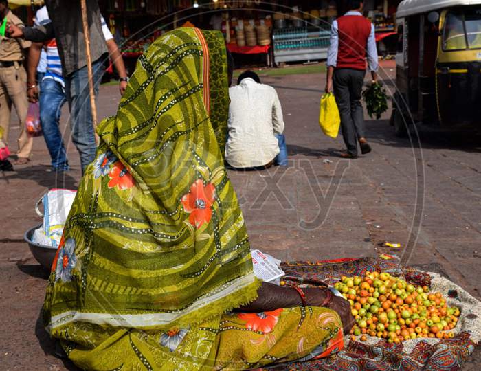 Back View Of Indian Old Lady Selling Jujube Fruits In The Market Area