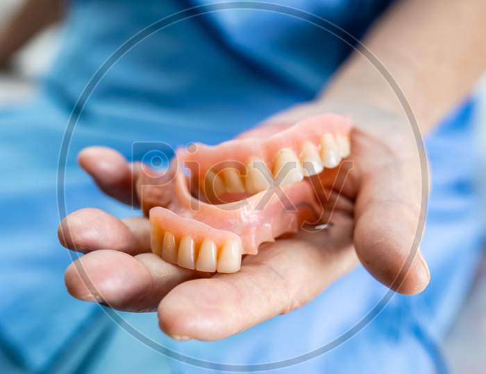 Asian Senior Or Elderly Old Woman Patient Holding To Use Denture In Nursing Hospital Ward, Healthy Strong Medical Concep