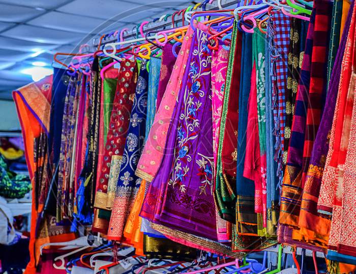 Stock Photo Of Beautiful Colorful Indian Saree Hung On Hanger In The Display Of Saree Shop