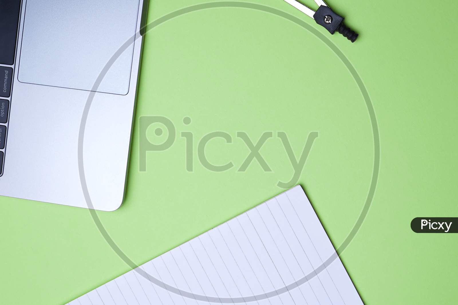 Business, Office, Student, Education Flat Lay, Table Top. Laptop, Compass, Spiral Notebook On Green Background