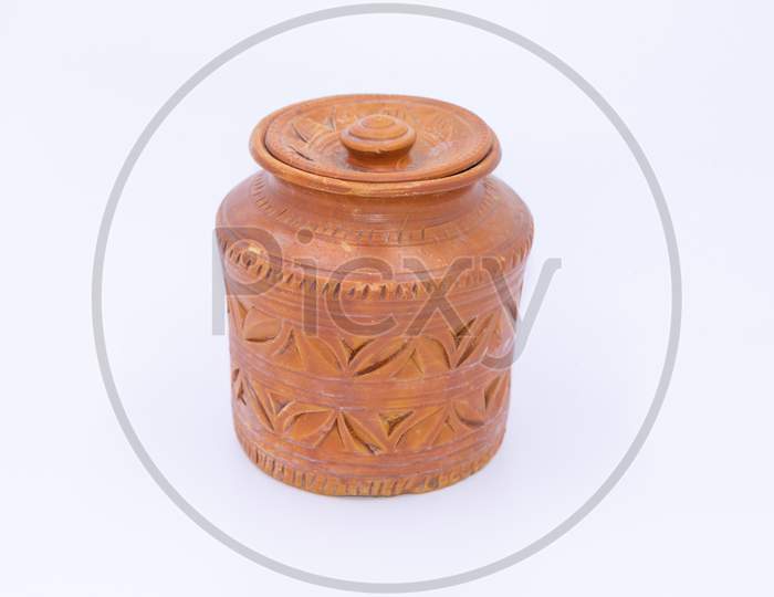 Close up of a jar made of clay with designs and patterns on it