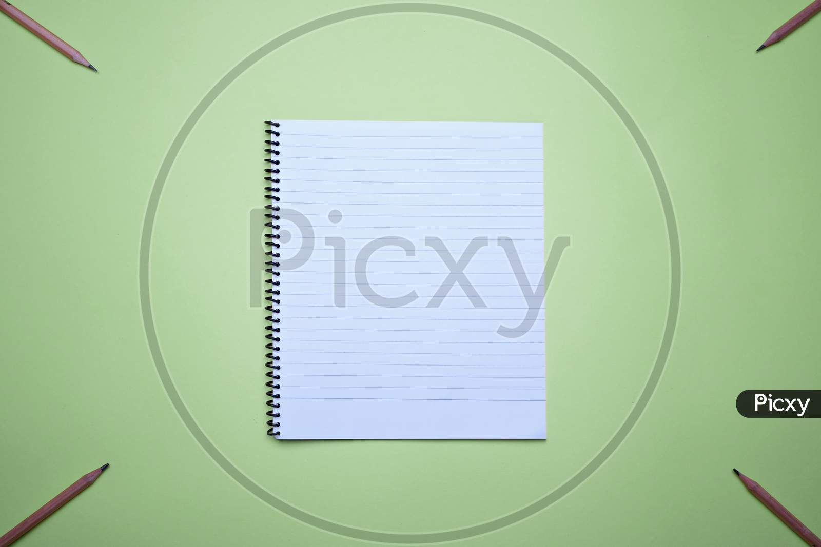 Spiral Notebook For Notes And Planning On A Green Background
